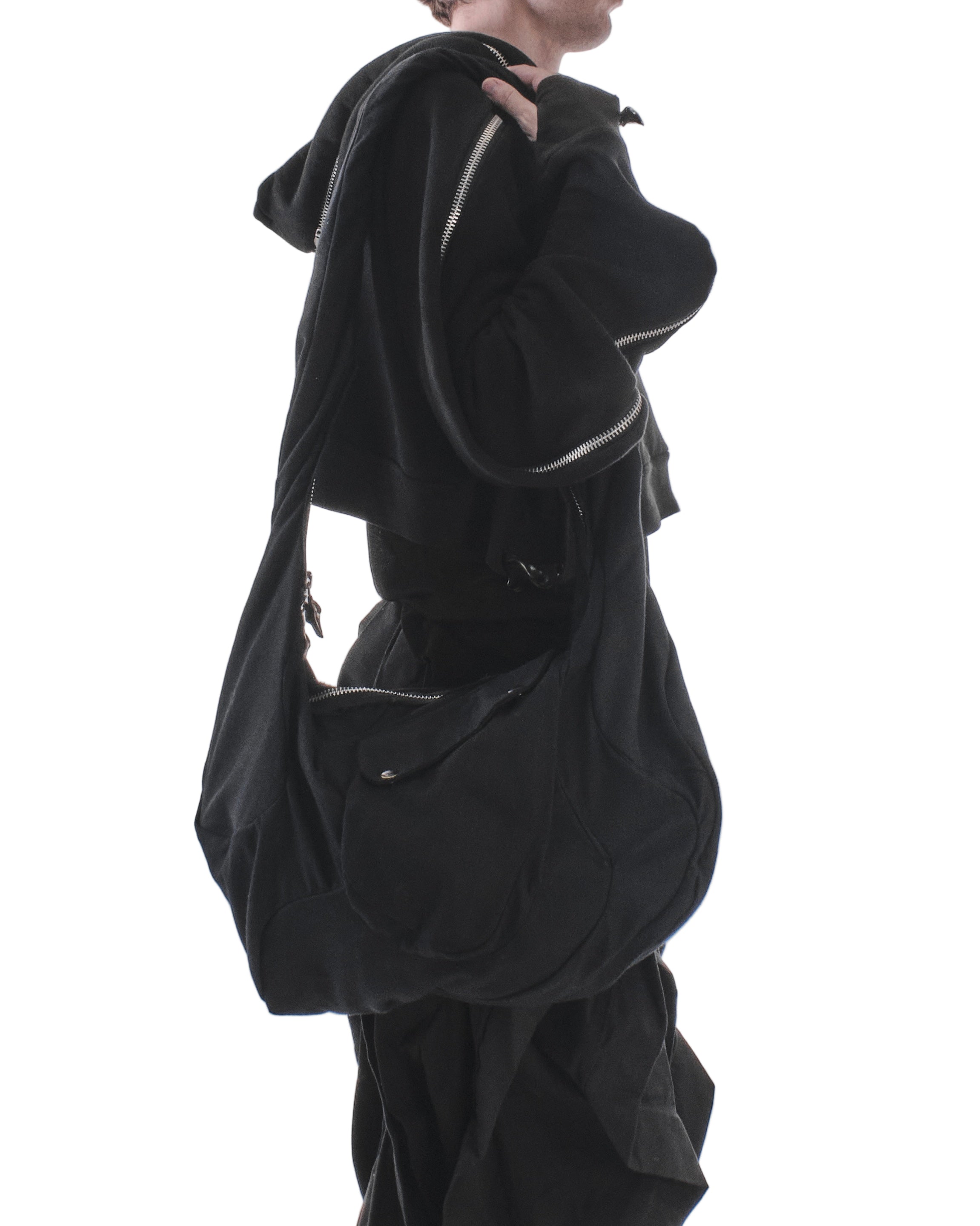 Person wearing a black outfit with a white background